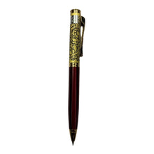 Golden engraved pen with red and gold twist design for refined and stylish writing.